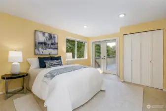 Large primary bedroom features direct access to the deck.