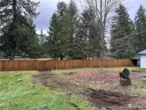 cross fenced in backyard, behind home