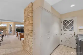 The back side of the fireplace is filled with additional storage. The cabinet closest to the Dutch door houses the water heater.