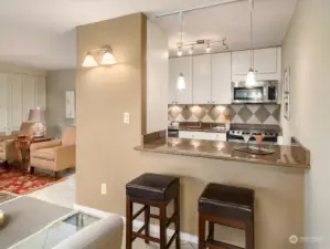 The breakfast bar at the kitchen counter is just perfect for a cup of coffee anytime.