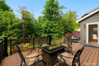 A blissful backyard sanctuary with seamless indoor-outdoor flow, showcasing expansive composite deck & tiled patio.