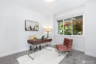 Office peacefully overlooks grand columned front porch.