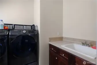 Main floor utility room with laundry sink.