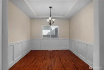 Formal dining room with wainscoting.