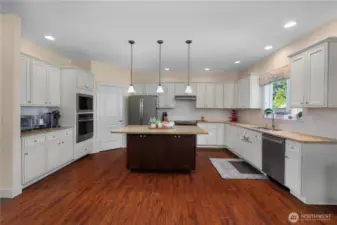 Beautiful Chef's kitchen with granite counters and subway tile backsplash, breakfast island, stainless steel appliances, and walk-in pantry.