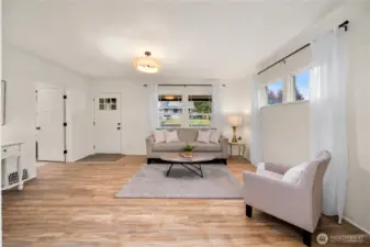 Living Room.  Notice the new lighting, new LVP flooring, new interior and exterior doors, black hardware, etc throughout.