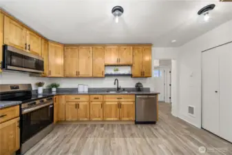 Wood cabinets, new lighting, new lvp waterproof flooring throughout the home (with no transition strips)!