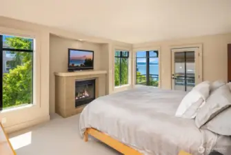 Primary Suite - with views galore, a private balcony, the 3rd gas fireplace in the house, and a spa like bathroom with soaking tub and shower...and walk-in closet, with laundry!