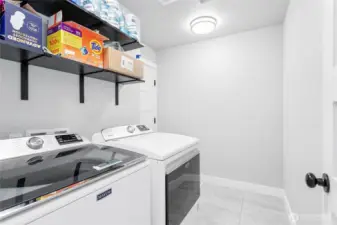 Separate washer/dryer room with door leading to the garage.