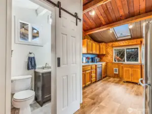 half bath off the kitchen. Classic wood paneling and millwork throughout.