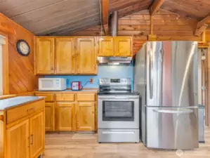 half bath off the kitchen. Classic wood paneling and millwork throughout.