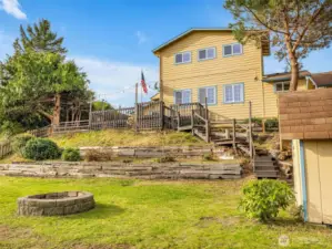 Tiered backyard with green house. Plenty of space for gardening. This yard is also fully fenced.