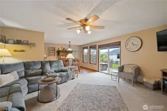 Living room open to the dining room and sliders to the backyard