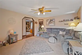 Living room open to the dining room and sliders to the backyard