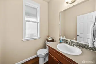 Convenient main-level powder room with stylish vanity and natural light.