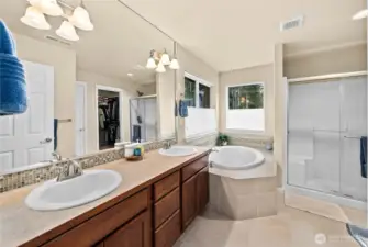 Spa-inspired primary bath featuring a dual vanity, generous counter space, and a bright, relaxing atmosphere.