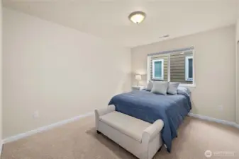 Bedroom 4: Light-filled bedroom with plush carpet and honeycomb window shades for privacy and adjustable natural light.