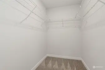 Primary suite walk-in closet offering ample space for organization.