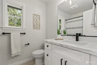 Fully remodeled full bathroom on the first floor features quartz countertops.