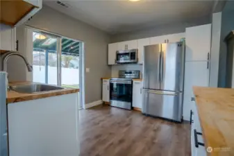 Updated kitchen with butcher block counter tops, newer appliances - included in sale.