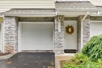 Two-car tandem garage with additional parking in front.