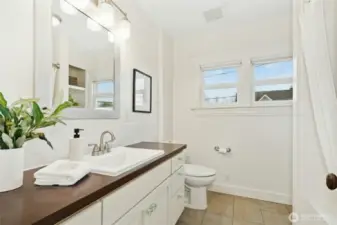 The 2nd floor bathroom has storage and plenty of space.