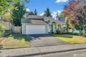 There is a sidewalk in front of the house.