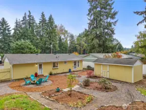 Spacious backyard with garden space, fire pit area, and your own large shed that could be your sanctuary!