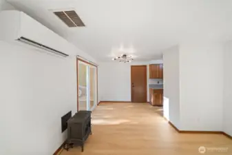 Living room is open to the dining room and kitchen. Door shown leads to the garage. New light fixture, new flooring!