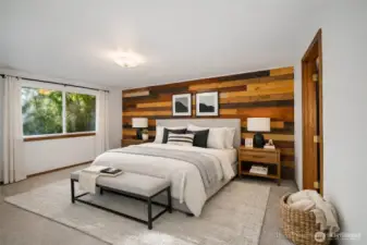 Upstairs the primary bedroom has a neat accent wall-very PNW. Virtually staged here