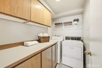Large, dedicated laundry room with plenty of storage and counter space.