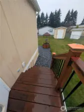 From back door looking over fenced backyard, garden shed, gravel area, etc.