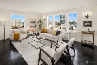 Extremely generous living room features high ceilings, parquet hardwoods + large windows that capture views to the north + east. This rooms leads graciously to the dining room and kitchen.