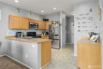 To the right is a kitchen walk in pantry and access to the garage and 1/2 bath