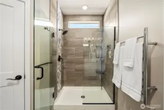 Fully tiled primary shower with  upgraded glass door, oil rubber bronze hardware & a heated towel rack (on a timer!).