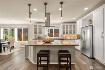 The stunning kitchen with Quartz counters, designer lighting (throughout), full heigh backsplash, 42' cabinetry with etched glass and top tier appliances make this kitchen a joy to entertain in!