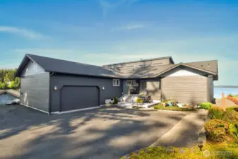 welcome home to this modern waterfront retreat- clean lines, spacious drive, inviting entry and timeless curb appeal
