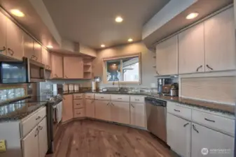 warm spacious kitchen with custom cabinetry with stylish backsplash perfect for everyday living and hosting