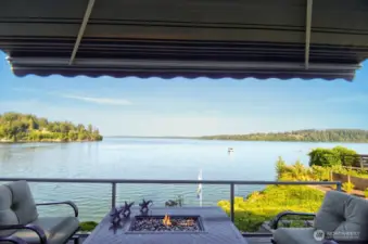 unwind fireside on your deck with sweeping water views, passing boats and tranquil PNW beauty all around