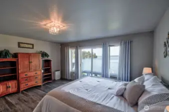 wake up to peaceful waters, sun kissed mornings and breathtaking views right outside your primary bedroom sliding glass door