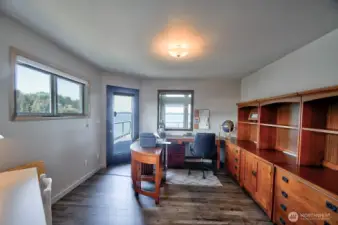 why commute? this main-floor bedroom turned office offers stunning water views and the ultimate work -from-home inspiration