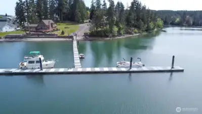 scenic private community dock and boat ramp surrounded by forested shorelines- your gateway to serene waterfront living and adventure