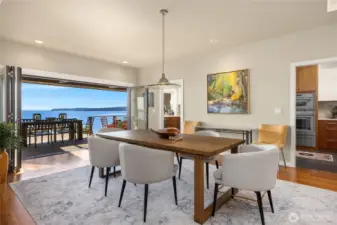The dining room opens to a covered heated patio overlooking the shimmering waters of Puget Sound.