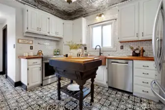 The tile floors, island & butcher block counters-chef kiss