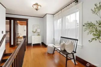 Landing with natural lgiht, fir wood floors-the perfect reading nook