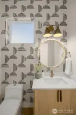 Powder bath with modern tile accent.