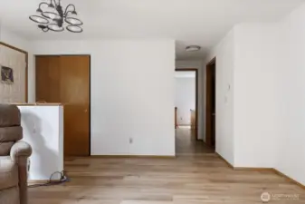Entrance to home, view of Living Room and hallway that leads to full bath, Primary Bedroom and 2 more bedrooms