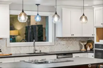 tile splash back and the honed black granite slab counter tops