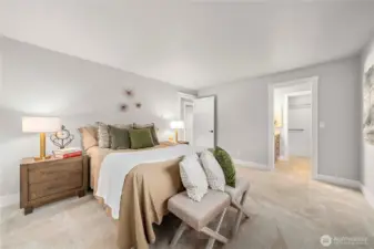 Primary bedroom with bath door showing in this photo