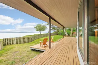 A covered porch runs the length of the house - enjoy the birds, the water traffic, the views, the beauty.